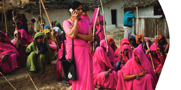 women gathered using cell phones to vote