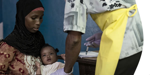 mother providing medicine to child