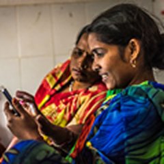 Two women looking at a mobile phone